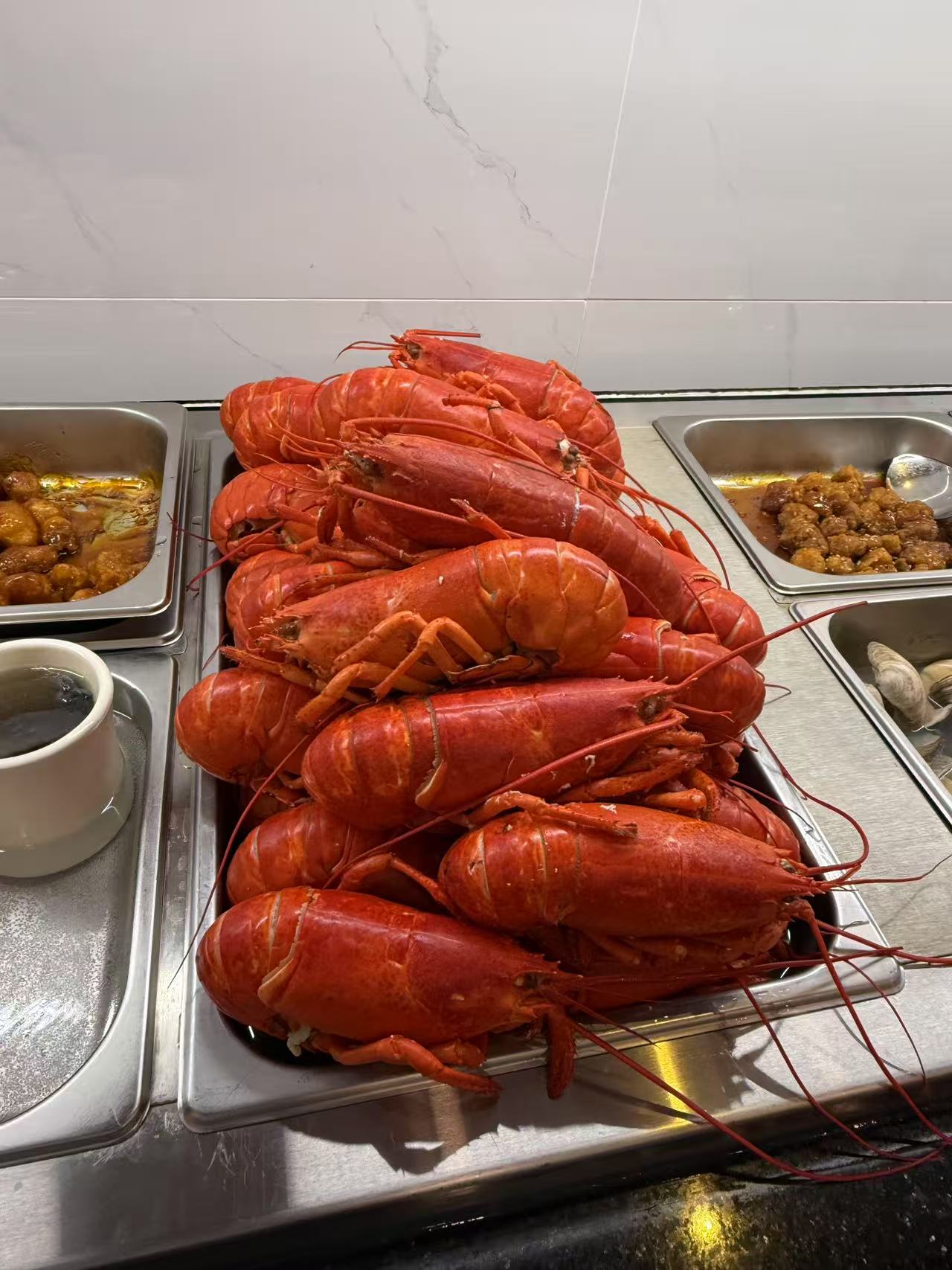 Steamed Lobsters - Freshly steamed lobsters ready for guests to enjoy at JW Asian Seafood Buffet, a Buffet restaurant in Long Island City