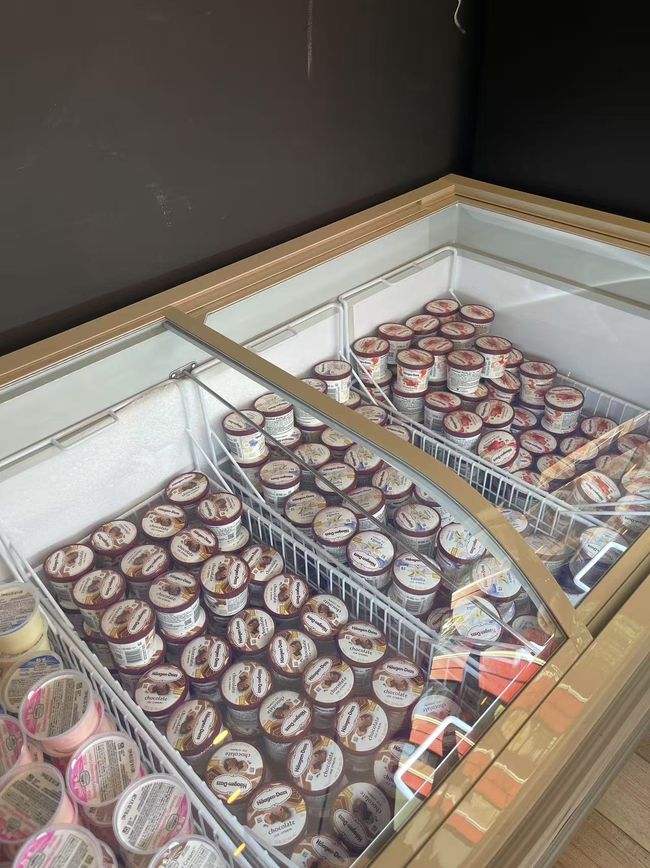 Ice Cream Selection - A variety of ice cream cups neatly arranged in a display freezer at JW Asian Seafood Buffet, a Buffet restaurant in Long Island City