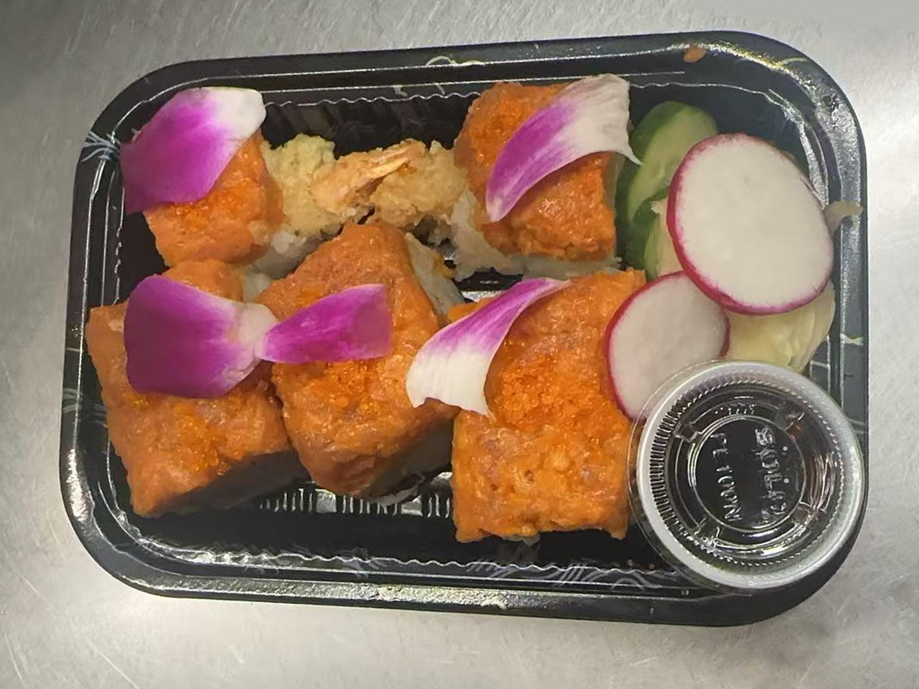 Red Sox Maki Sushi rolls with fresh ingredients and edible flowers at Kakkoii Sushi and Ramen, a Japanese restaurant in Malden