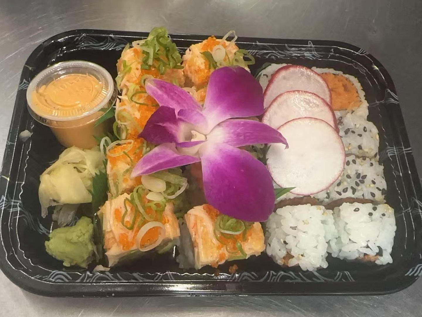Volcano Maki Spicy Tuna Maki Assorted sushi rolls with garnishes at Kakkoii Sushi and Ramen, a Japanese restaurant in Malden