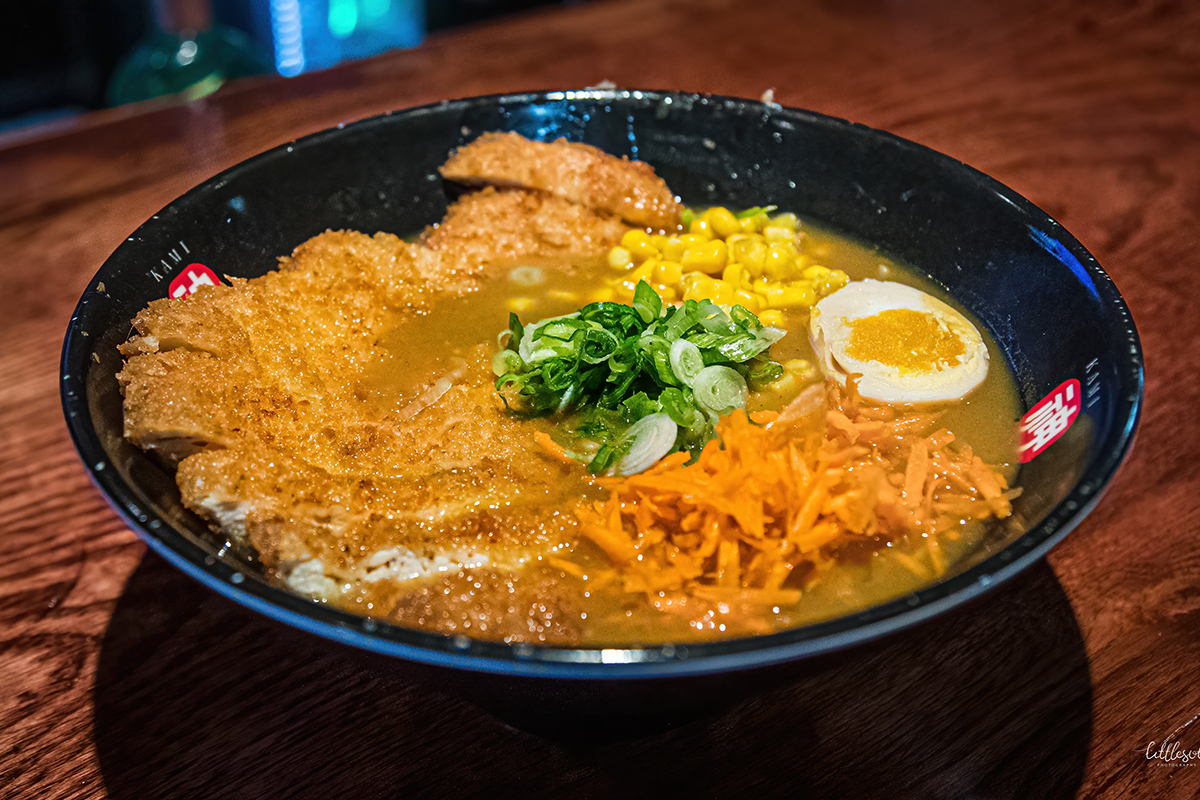 Curry ramen topped with crispy pork cutlet, corn and soft-boiled egg at Kami Ramen & Sushi, a Japanese Restaurant in Humble。