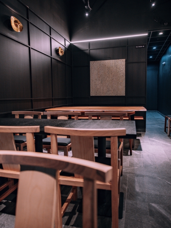 Spacious dining room with wooden tables and chairs at Kanpai Ramen, a Ramen Restaurant in New Port Richey