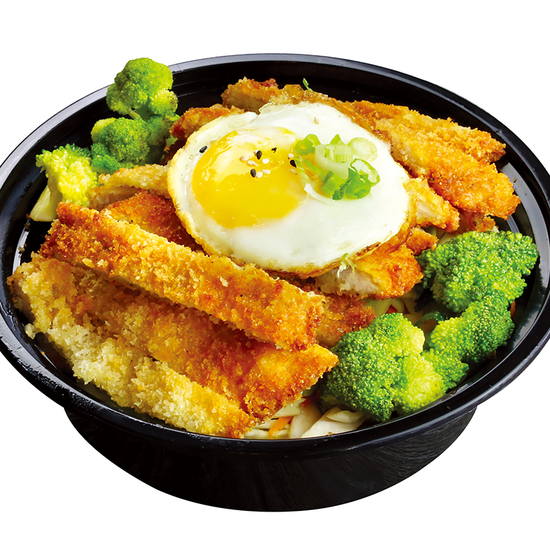 Crispy pork cutlet rice bowl with fried egg and fresh broccoli florets at K-Bop, a Korean Restaurant in Austin