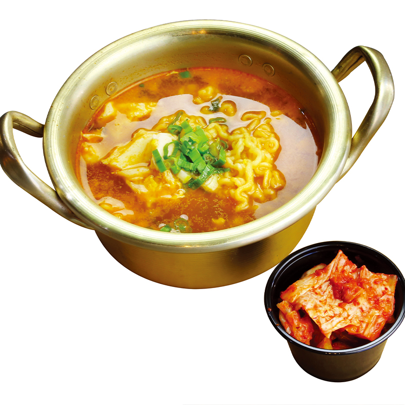 Kimchi ramen tofu soup with green onions and side pickled cabbage at K-Bop, a Korean Restaurant in Austin