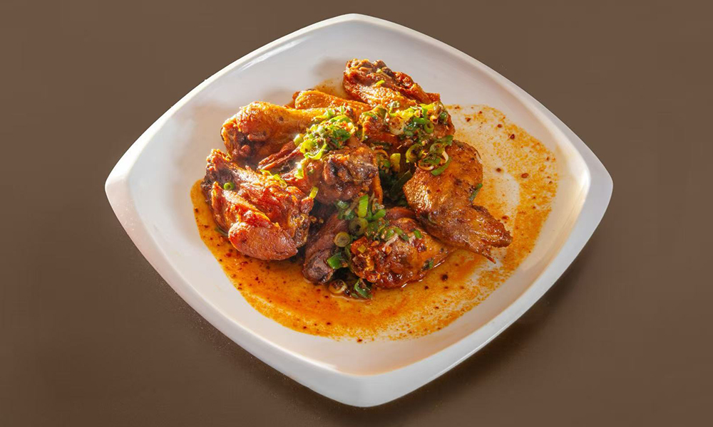 Spicy chicken wings with green onions at Kenichi Asian Bistro, a Asian Restaurant in Worcester