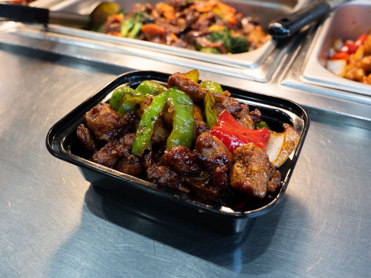 Spicy stir-fried chicken with green and red peppers at Kennys Wok, a Chinese Restaurant in Philadelphia