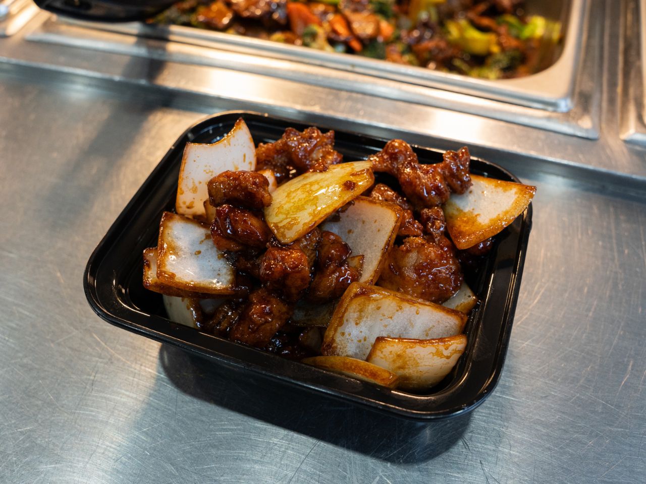 Crispy chicken in spicy-sweet sauce with onions at Kennys Wok, a Chinese Restaurant in Philadelphia