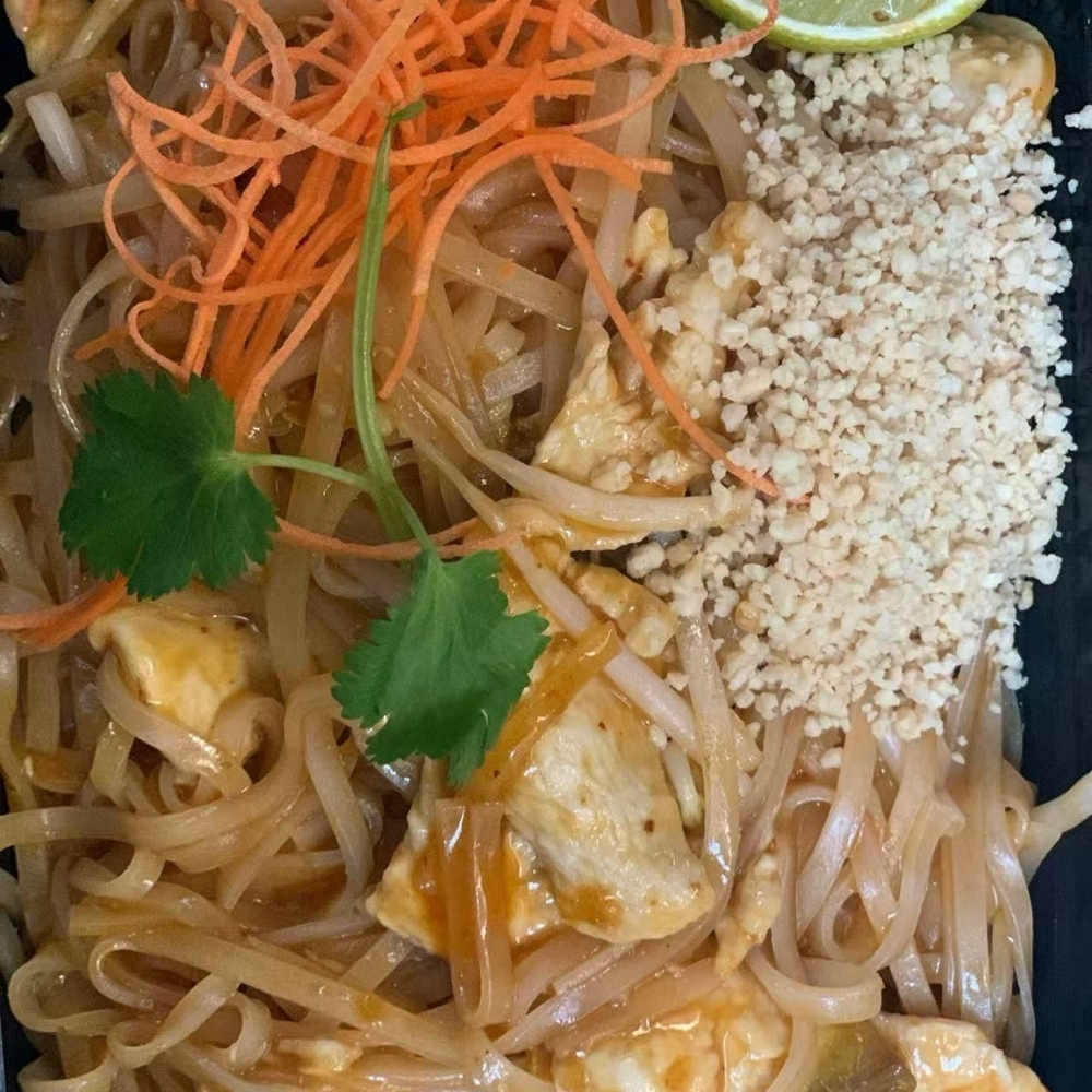 Chicken pad thai noodles with carrot, cilantro and crushed peanuts