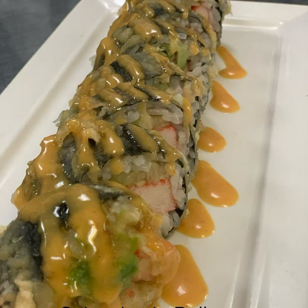 Tempura sushi roll topped with spicy creamy sauce