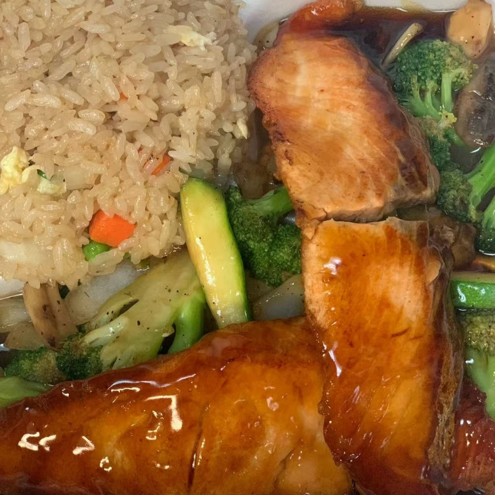 Teriyaki salmon fillets with fried rice and mixed vegetables