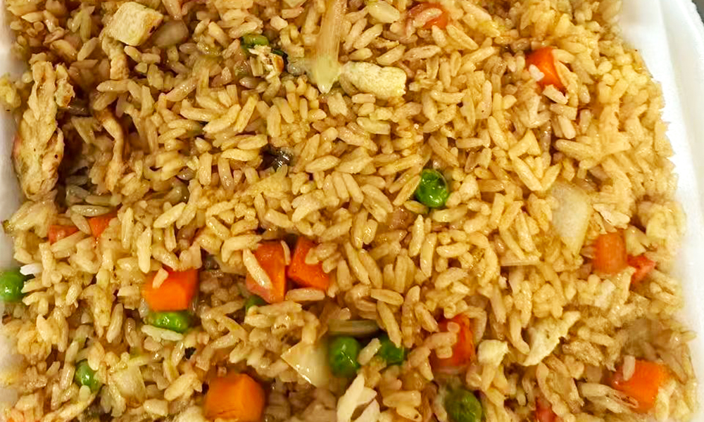 Fried rice mixed with chicken, carrots, peas, and other vegetables at Kick Off Wings, a Fast Food Restaurant in Carrollton