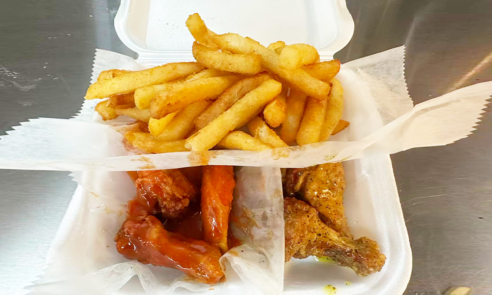 Chicken wings with two different flavors and a side of French fries at Kick Off Wings, a Fast Food Restaurant in Carrollton