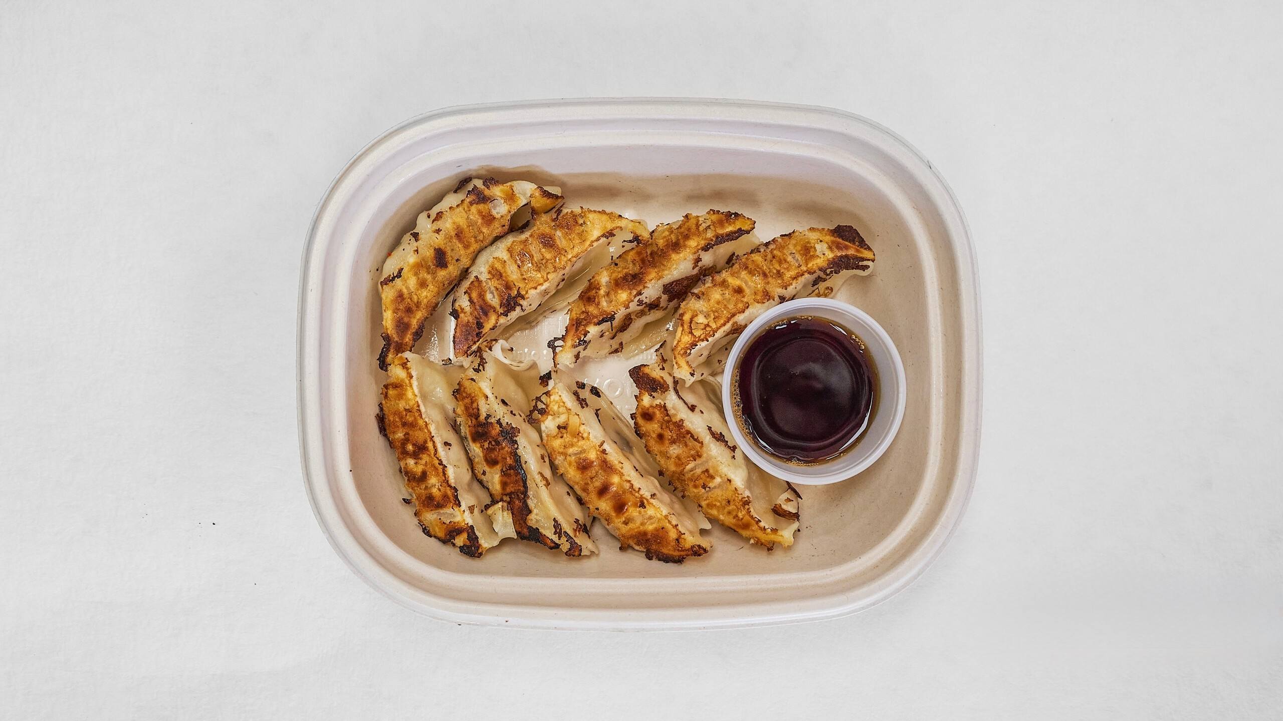 Pan - fried chicken dumplings with soy sauce dip at Kimchi & Ramen Express Train,a Korean Restaurant in Cape Elizabeth