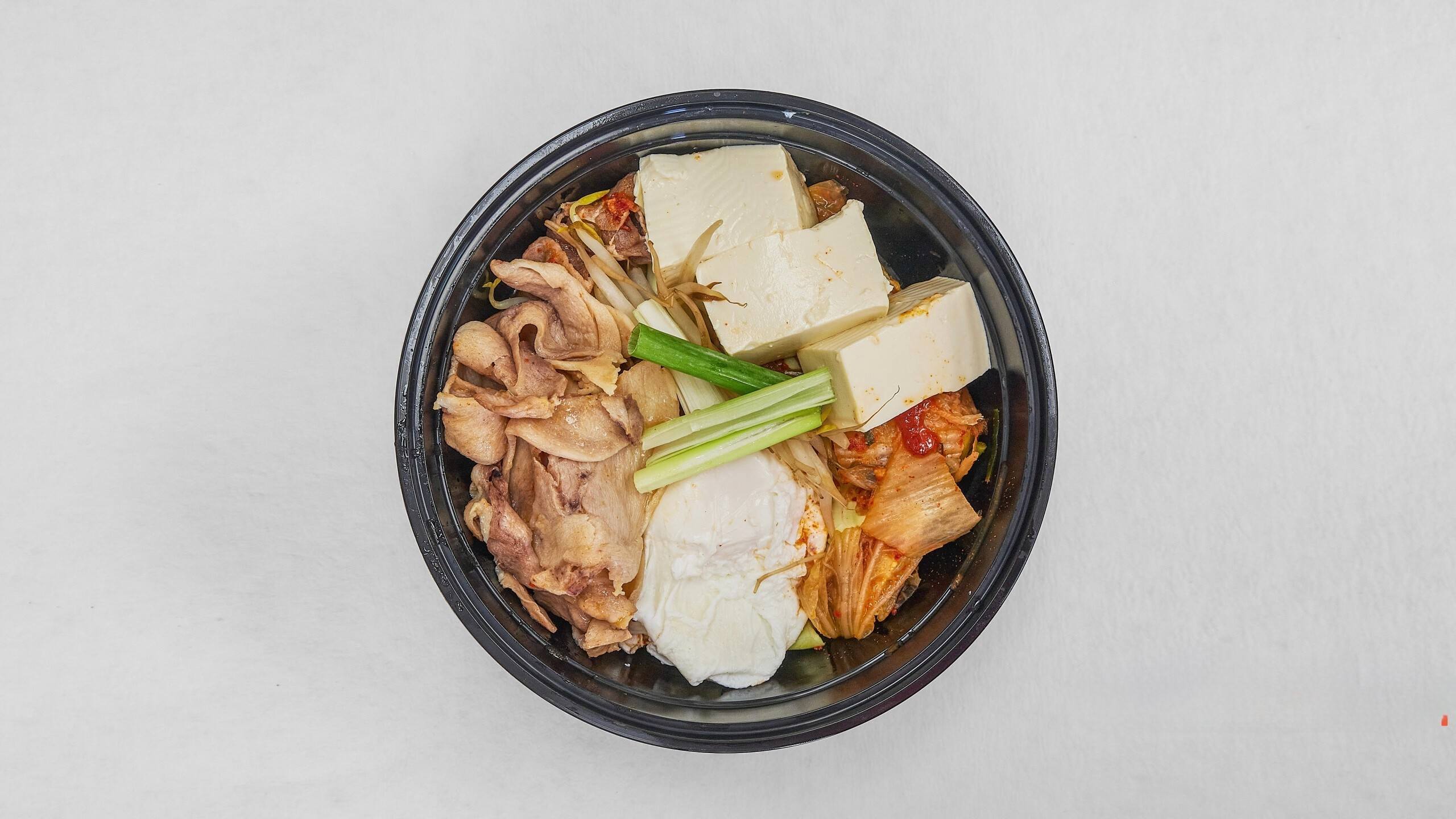 Chicken tofu stew with kimchi, savory soup at Kimchi & Ramen Express Train,a Korean Restaurant in Cape Elizabeth