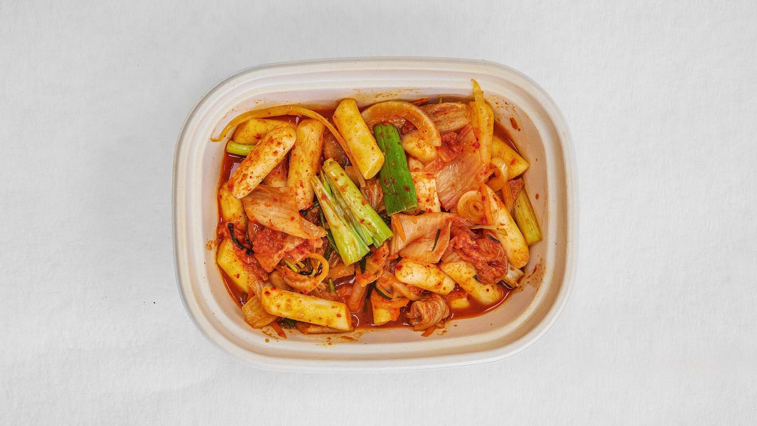 Spicy kimchi - fried rice cakes with scallions at Kimchi & Ramen Express Train,a Korean Restaurant in Cape Elizabeth