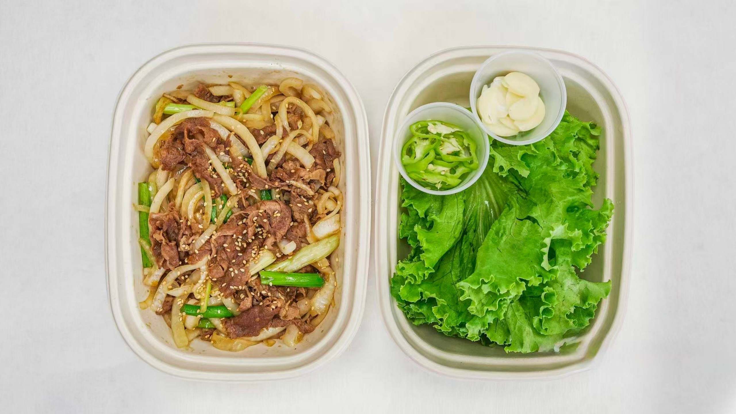 Korean BBQ beef rice bowl with veggies and condiments at Kimchi & Ramen Express Train,a Korean Restaurant in Cape Elizabeth