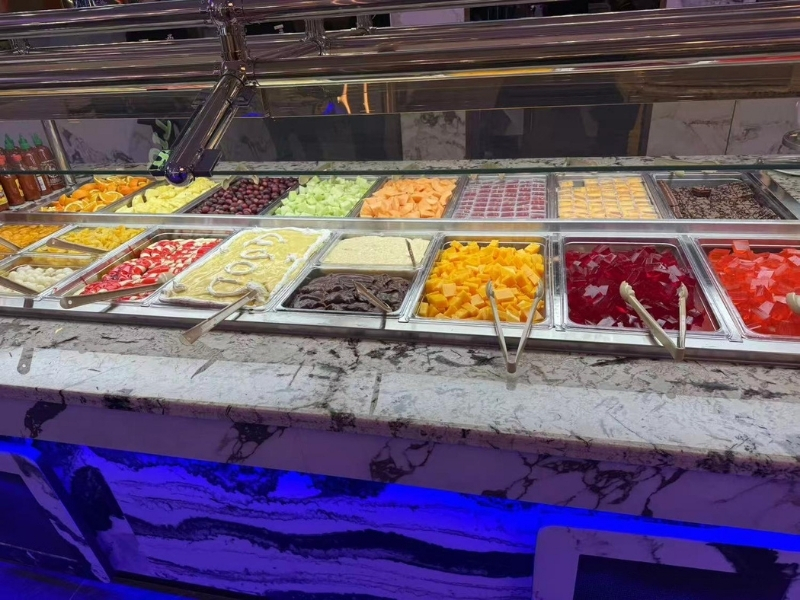 Dessert and fruit bar with cakes, jellies, and fresh fruits at King Buffet, a Buffet Restaurant in Westminster.