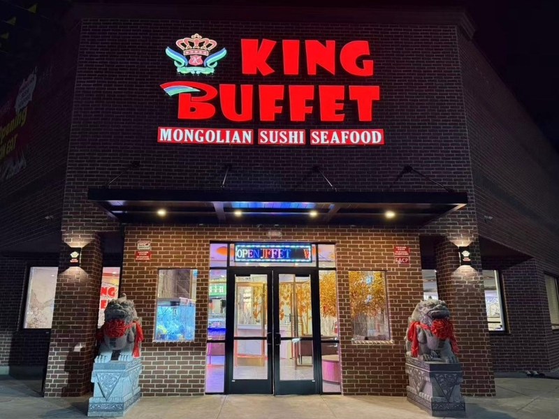 Brick exterior with neon sign and stone lions at King Buffet, a Buffet Restaurant in Westminster.