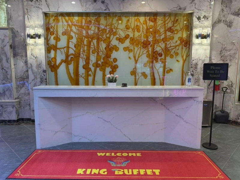 Reception desk with fruit tree mural and welcome mat at King Buffet, a Buffet Restaurant in Westminster.