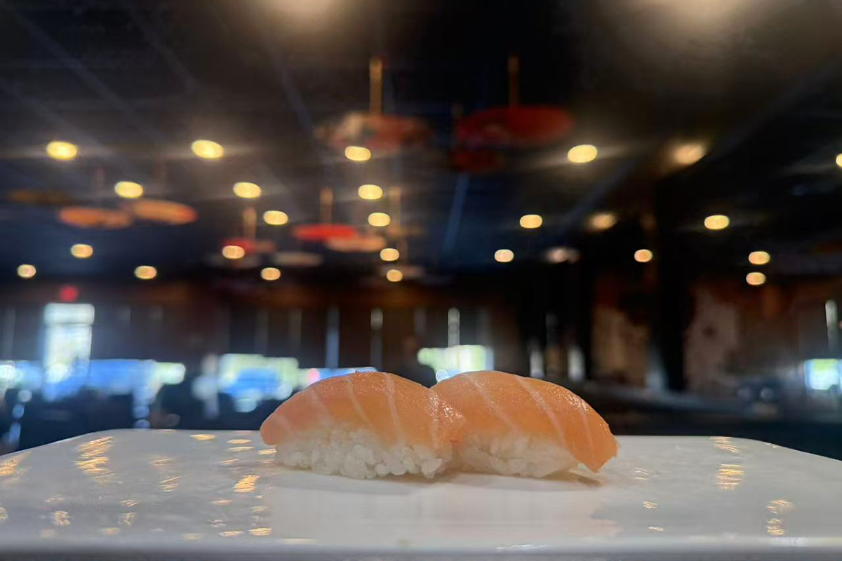 Two pieces of salmon nigiri sushi on white plate at Kings Sushi, a Japanese Restaurant in Summerville