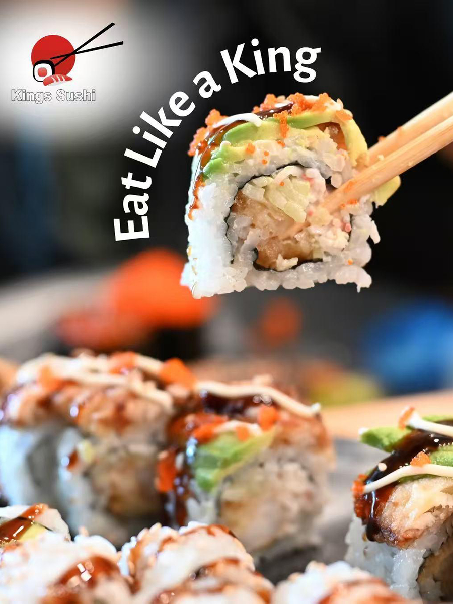 Sushi roll with avocado crab and tobiko held by chopsticks at Kings Sushi, a Japanese Restaurant in Summerville