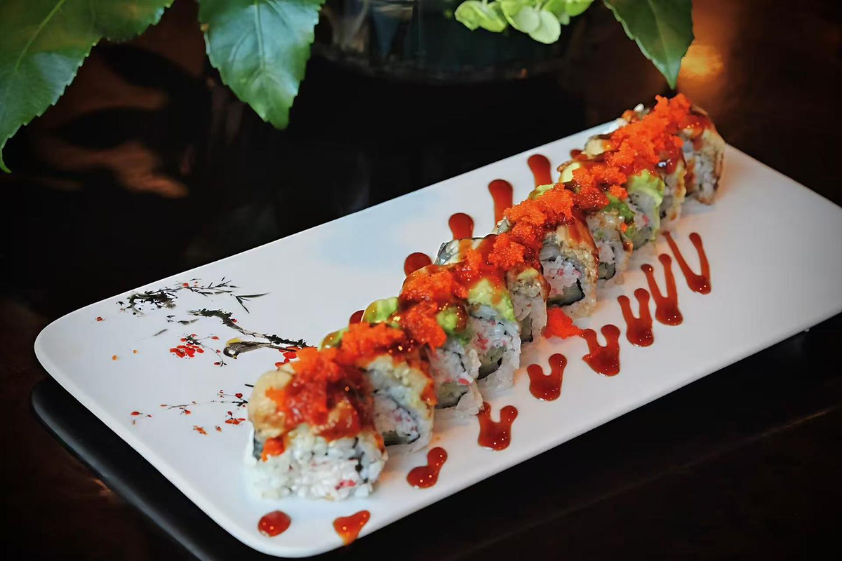 Sushi roll with masago avocado eel and unagi sauce on plate at Kings Sushi, a Japanese Restaurant in Summerville
