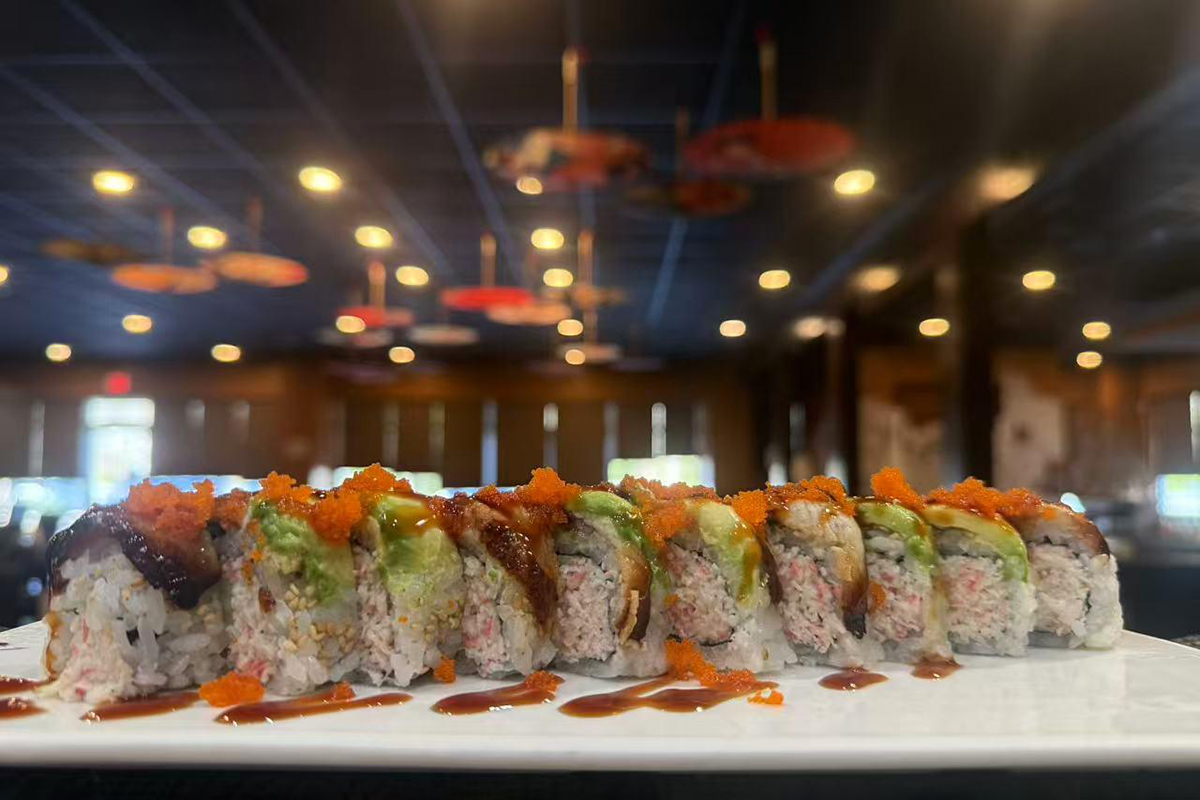 Sushi roll with crab avocado eel and masago on white plate at Kings Sushi, a Japanese Restaurant in Summerville