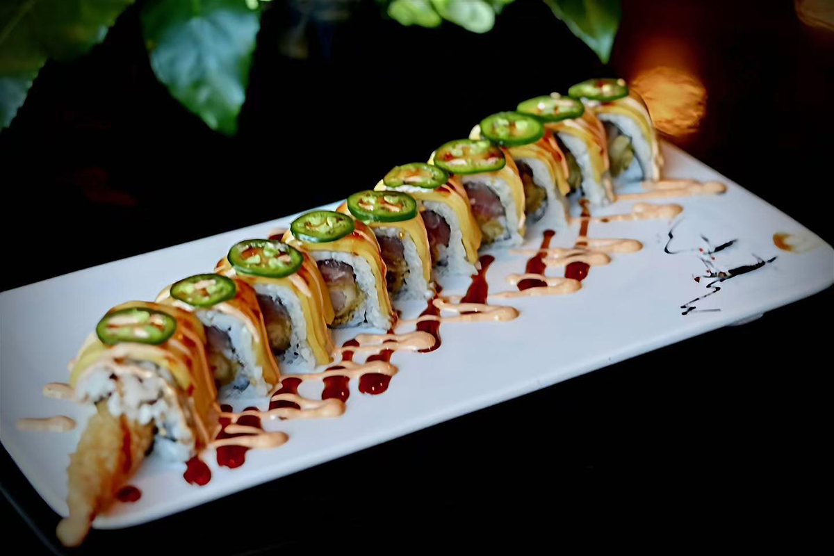 Sushi roll with mango jalapeño tempura and two sauces on white plate at Kings Sushi, a Japanese Restaurant in Summerville