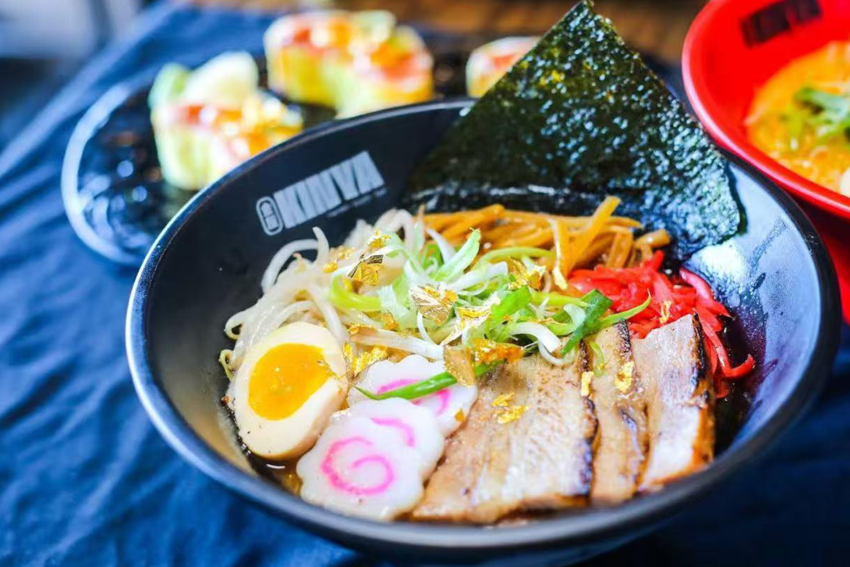 Pork broth with black garlic oil, fish cake, scallions, bean sprouts, bamboo shoots, boiled egg and 24k gold at Kinya, a Japanese Restaurant in Gainesville