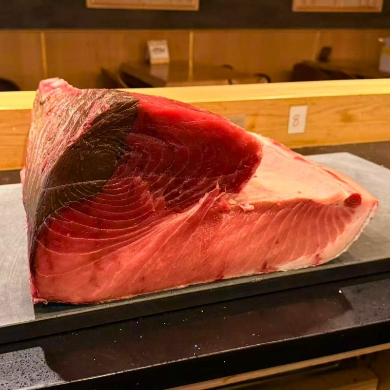 Big marbled raw tuna chunk on stone board at Ki Omakase, a Sushi Restaurant in Little Neck
