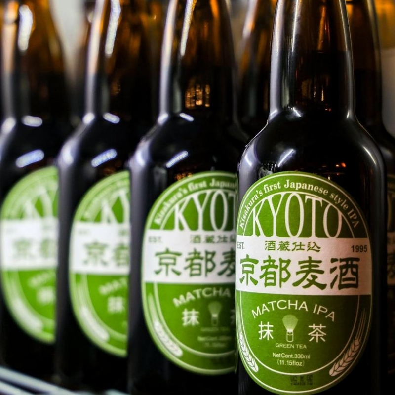 Neat lined Kyoto matcha IPA beer bottles on shelf at Ki Omakase, a Sushi Restaurant in Little Neck