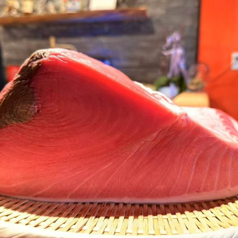 Vibrant red raw tuna loin laid on bamboo mat at Ki Omakase, a Sushi Restaurant in Little Neck