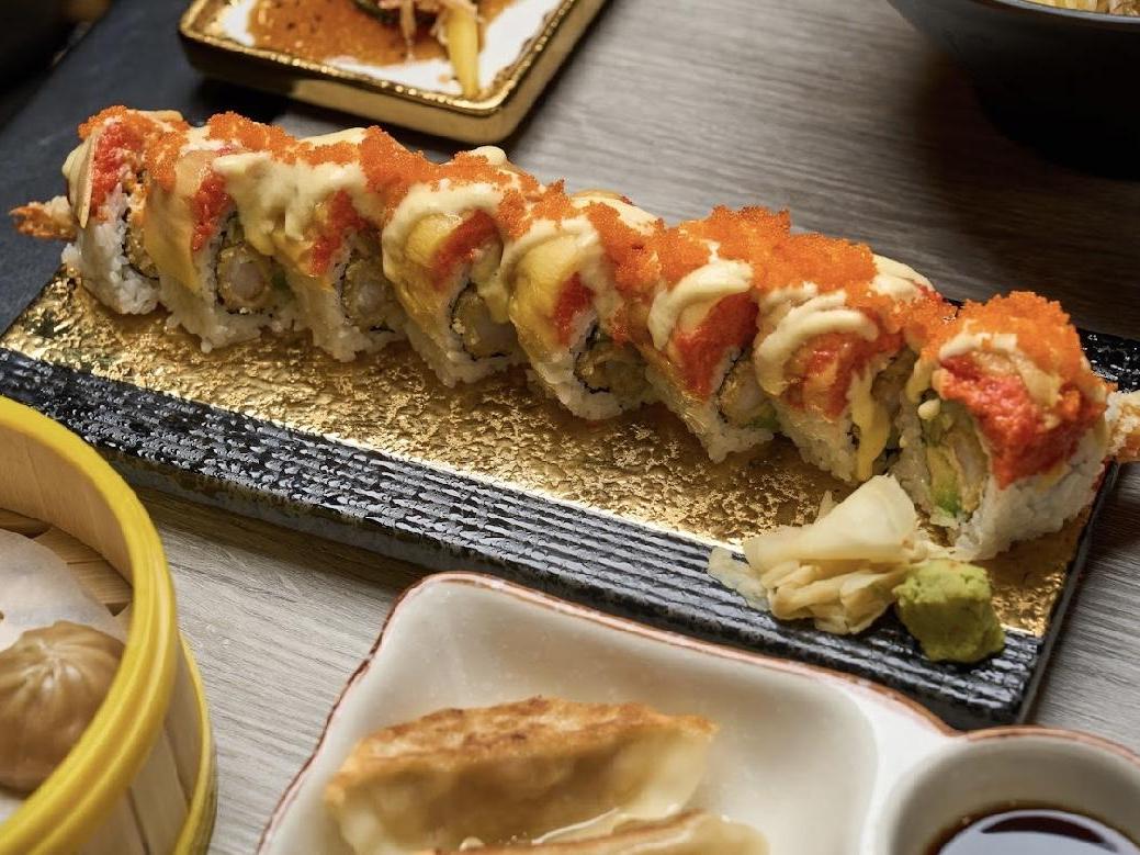 Sushi roll with tempura, avocado and tobiko topped with sauce at Kiwami Ramen & Sushi, a Japanese Restaurant in Overland Park