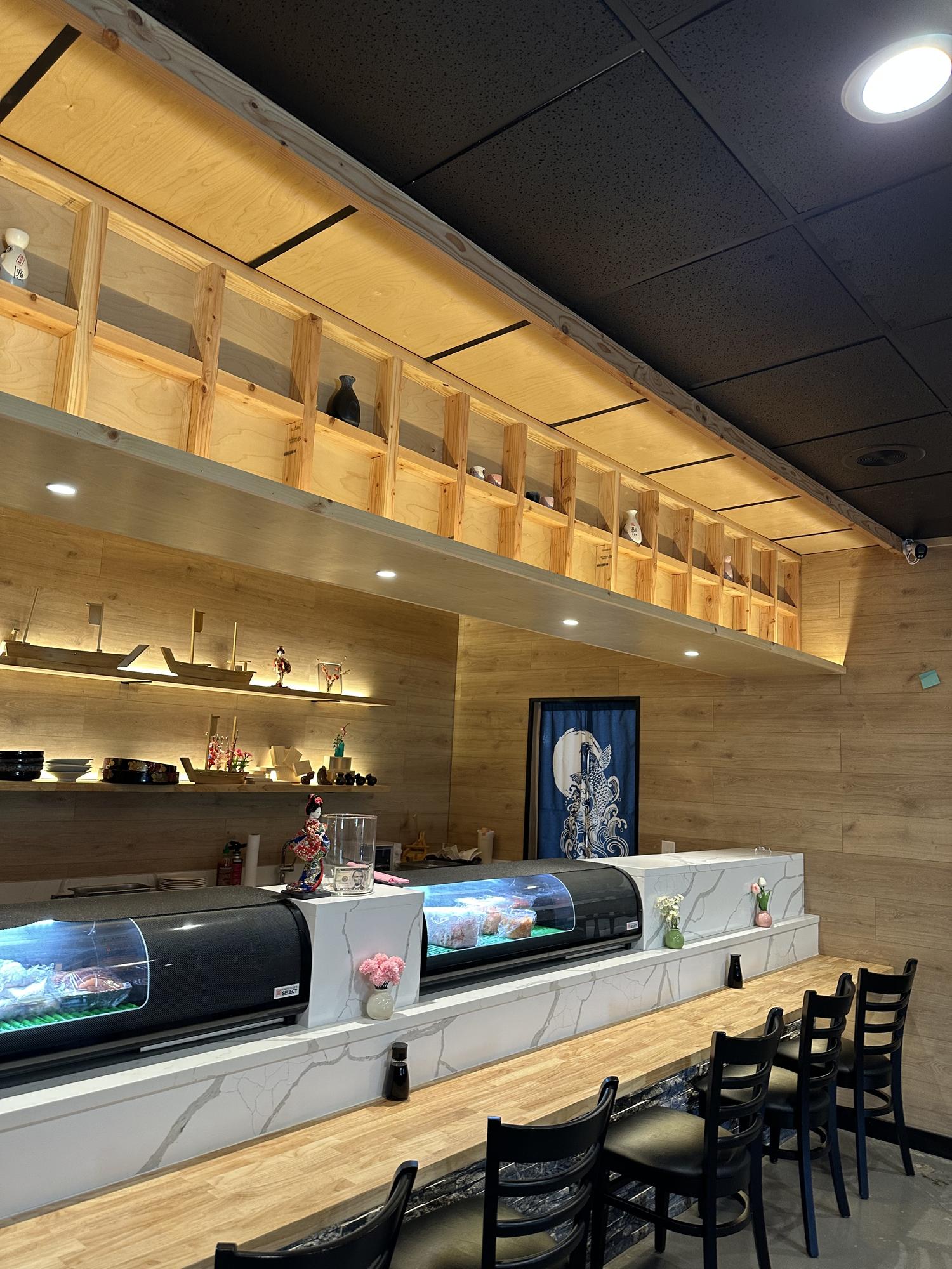 Marble-topped sushi bar with chilled food display and seating at Kiwami Ramen & Sushi, a Japanese Restaurant in Overland Park