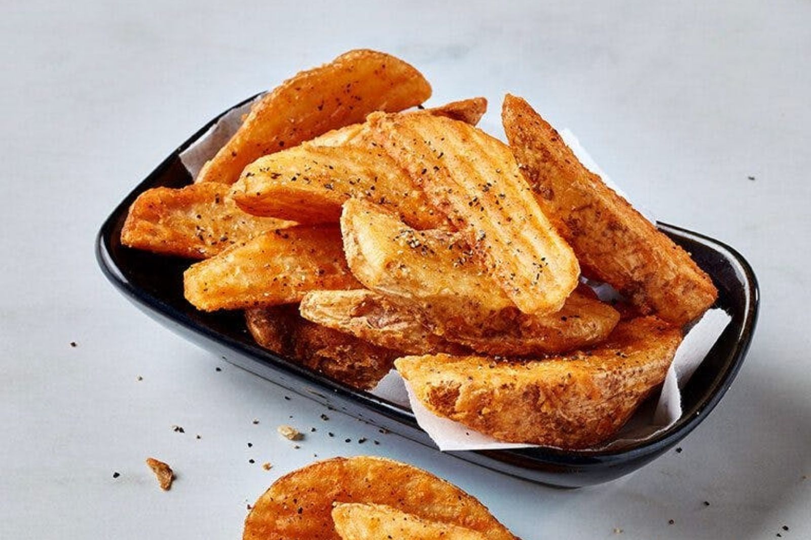 Crispy seasoned potato wedges with spices at Krispy Krunchy Chicken - Halal, a Fast - Food in Richardson