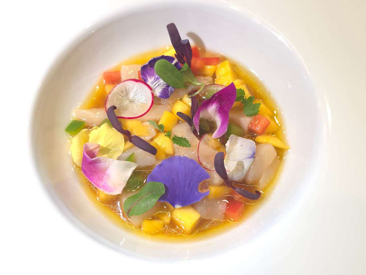 Vibrant seafood ceviche garnished with edible flowers at KoBu, a Japanese Sushi & Omakase Restaurant in Jacksonville