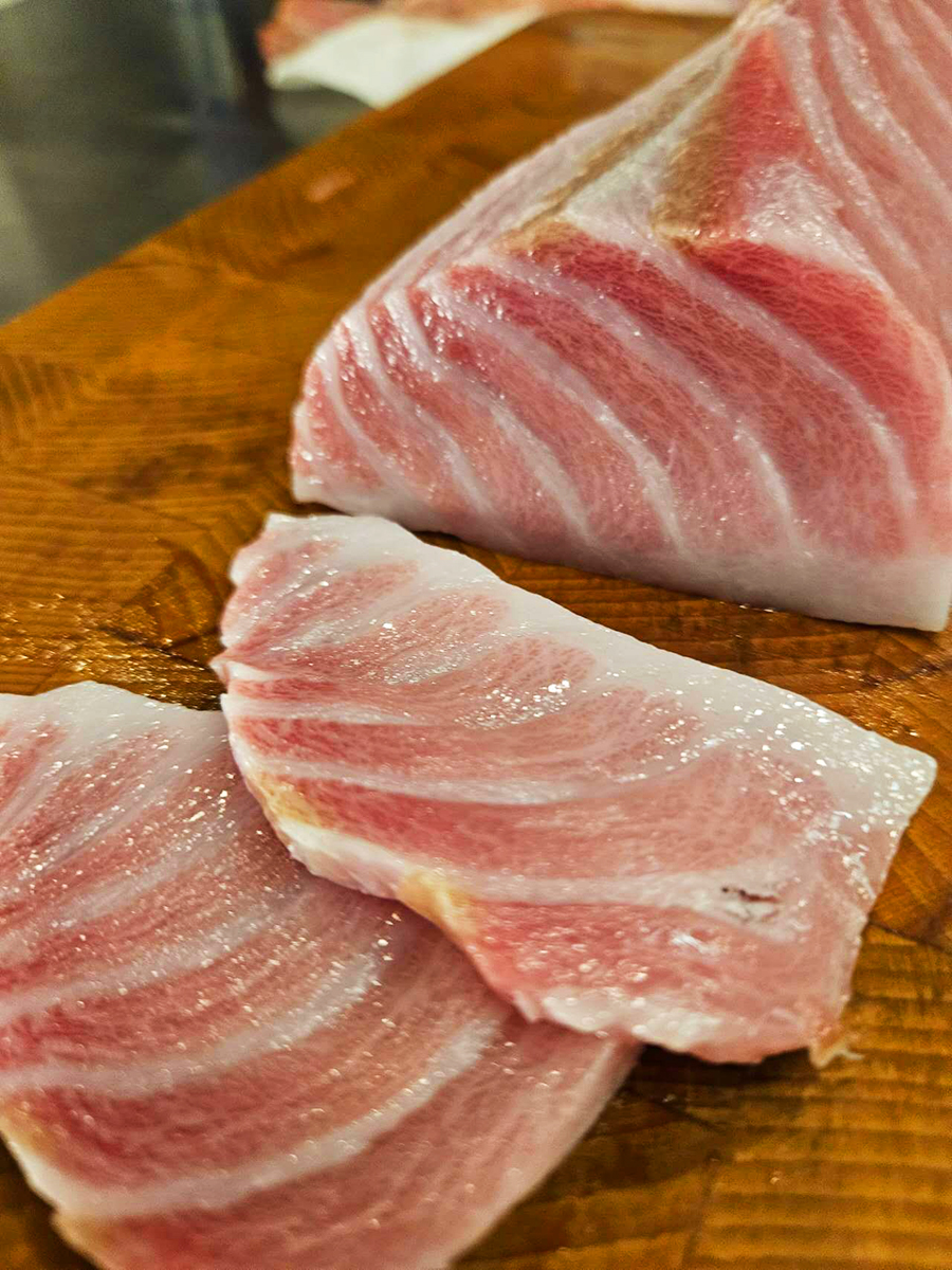 Marbled otoro tuna slices on a wooden board at KoBu, a Japanese Sushi & Omakase Restaurant in Jacksonville