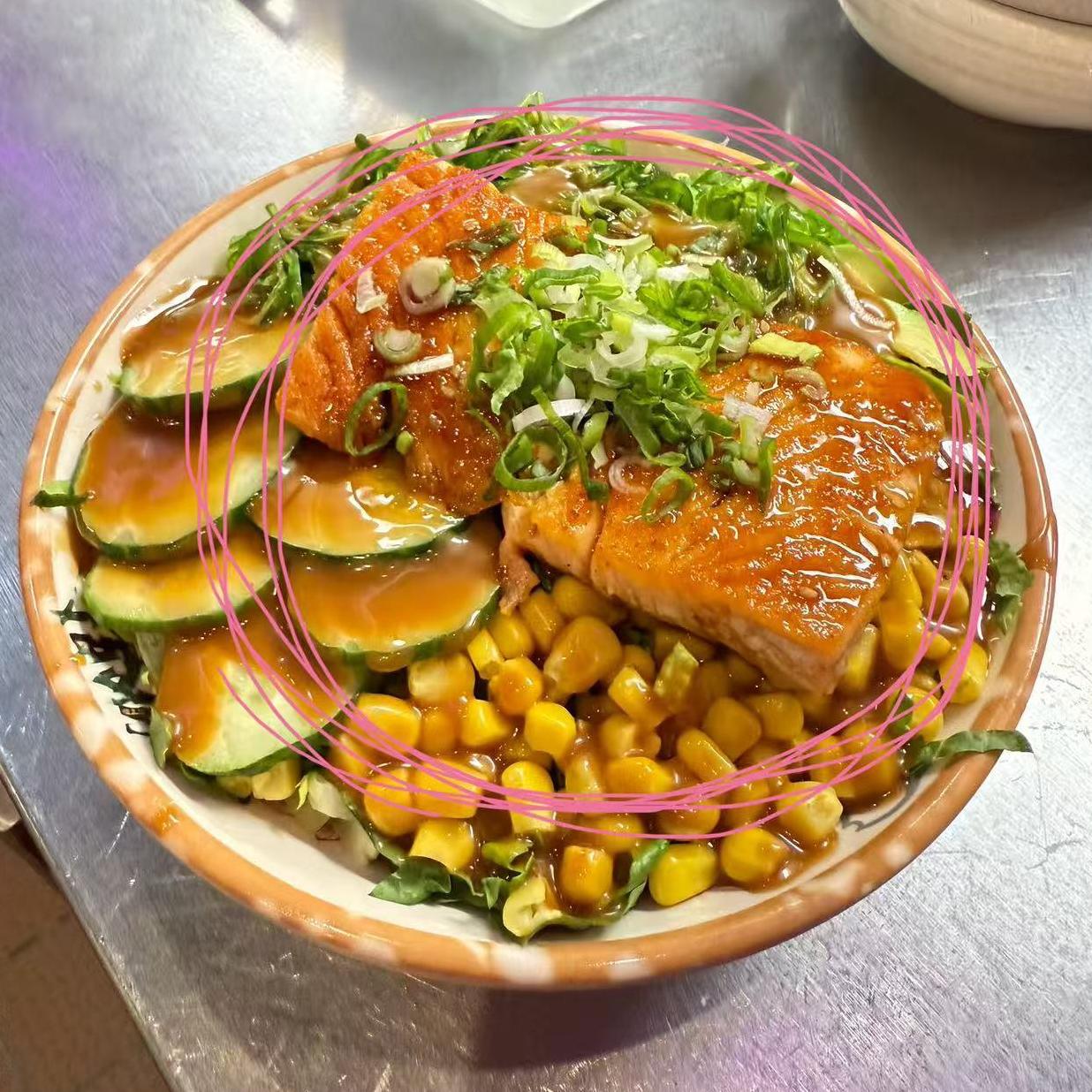 Salmon Rice Bowl - Grilled salmon on rice with cucumber, corn and green onions at Koi Ramen & Sushi, a Japanese Restaurant in Grand Junction