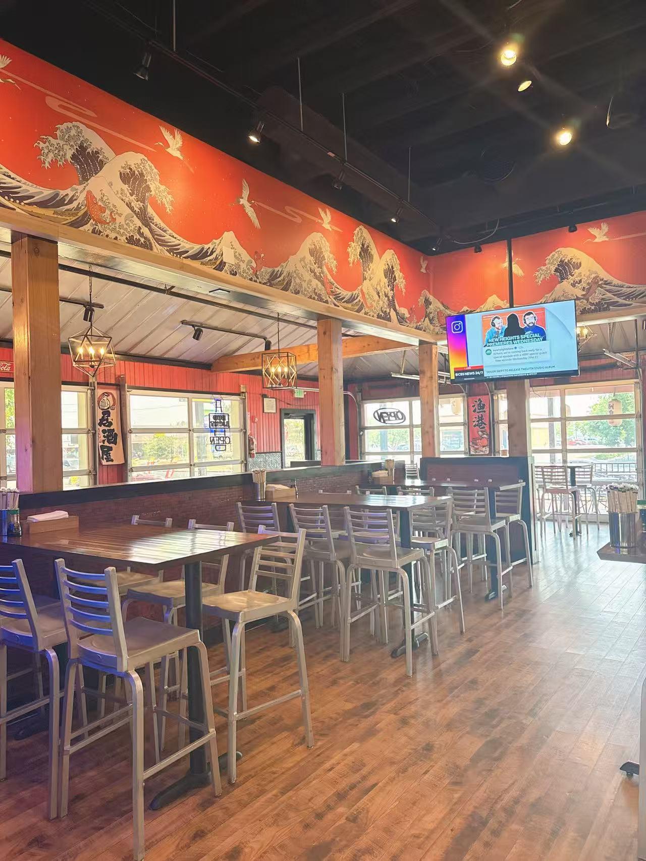 Dining Area - Spacious dining space with wooden tables, high chairs and a TV at Koi Ramen & Sushi, a Japanese Restaurant in Grand Junction