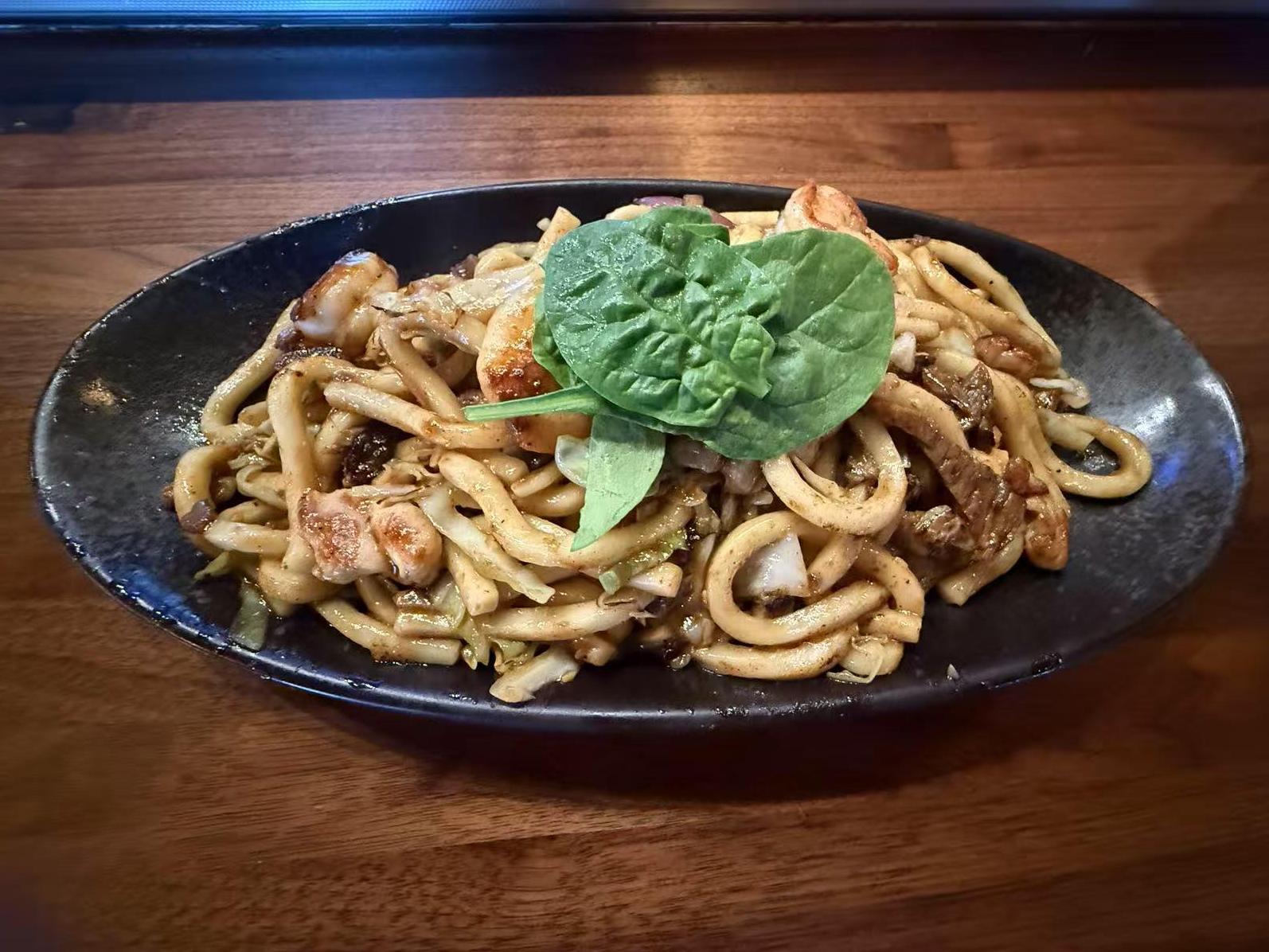 Yaki Udon - Stir - fried udon noodles with chicken, shrimp and vegetables at Koi Ramen&Sushi, a Japanese restaurant in Hutchinson