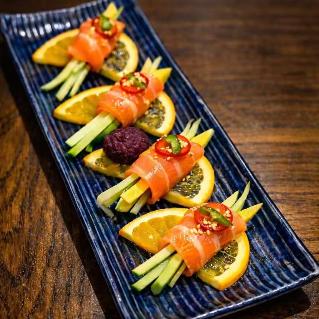 Smoked salmon rolls with orange slices and cucumber sticks at KOJO Asian Fusion, a Asian Fusion Restaurant in Franklin