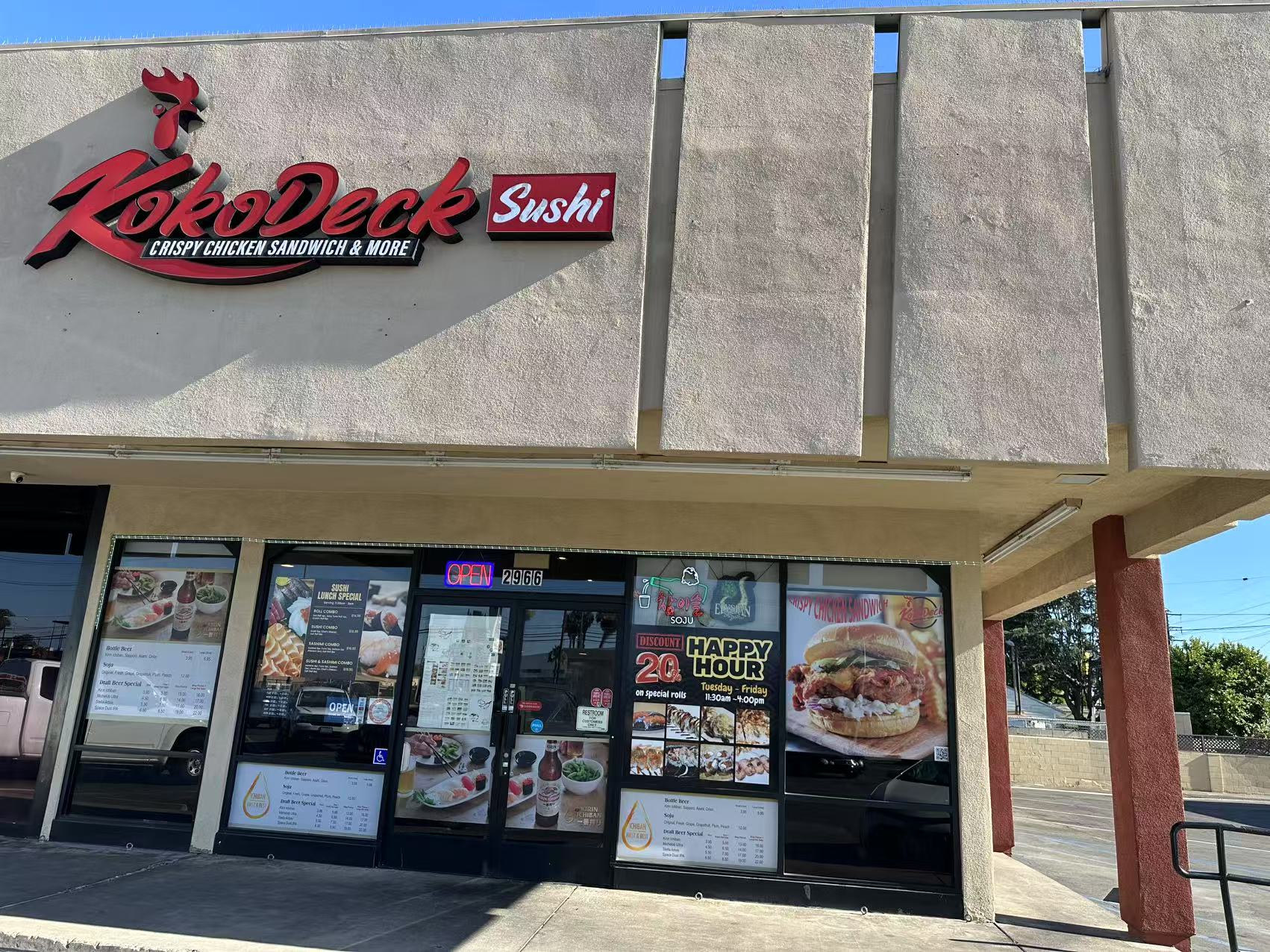 Restaurant Exterior - Storefront with "Kokodeck Sushi" signage and promotional posters at Kokodeck Sushi, a Japanese restaurant in Anaheim