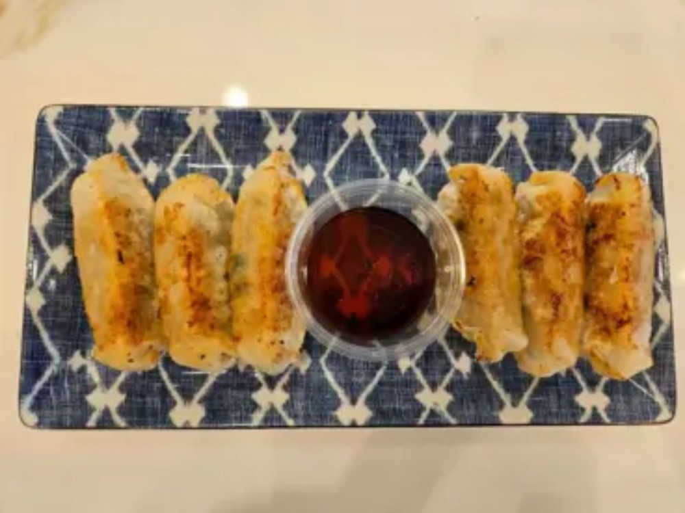 Golden pan fried potstickers with soy dip at KOKORO House Of Ramen, a Ramen Restaurant in Glen Rock