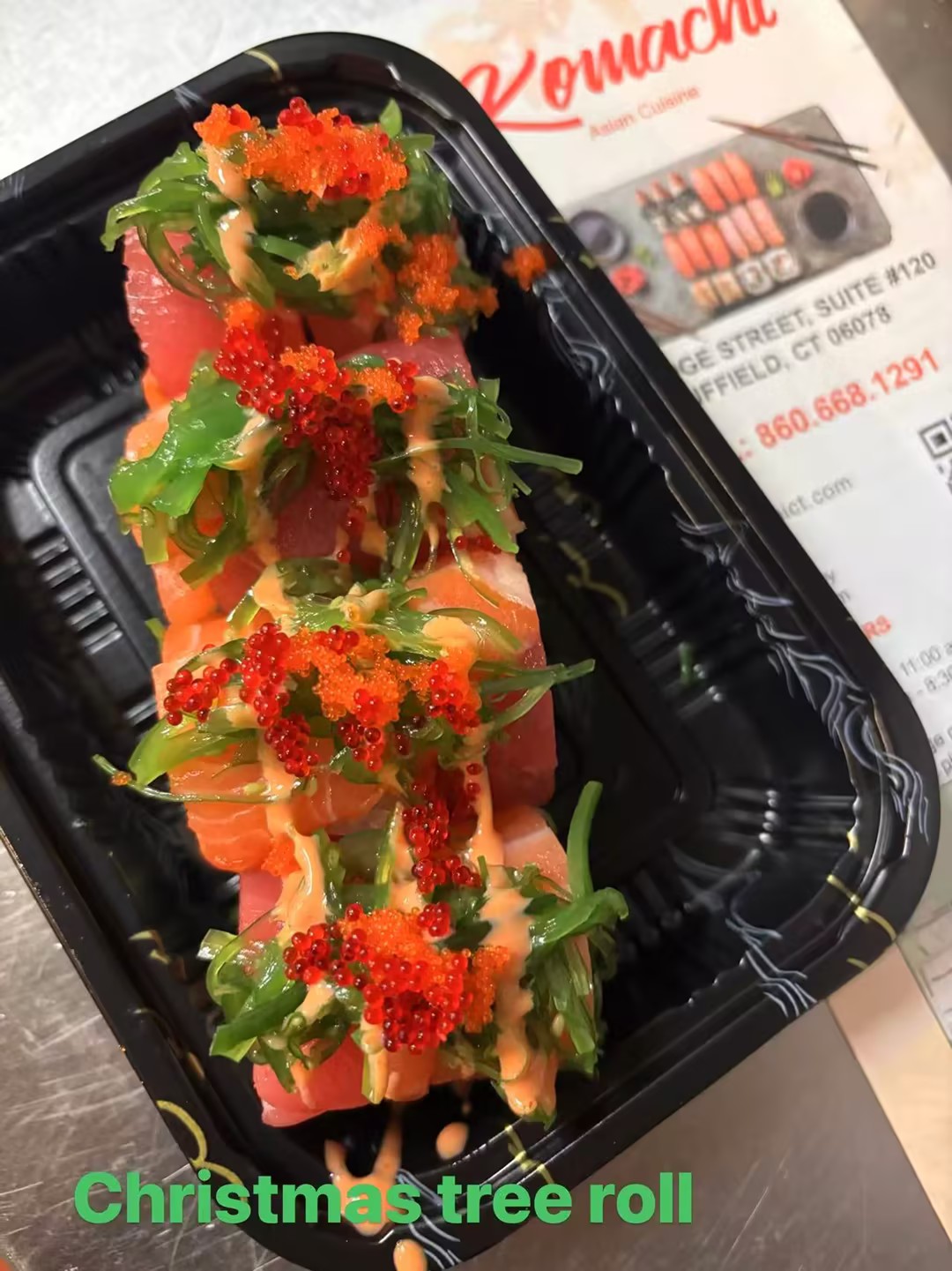 Sushi roll with fish, seaweed, tobiko and sauce, styled like a Christmas tree at Komachi, a Asian Restaurant in Suffield