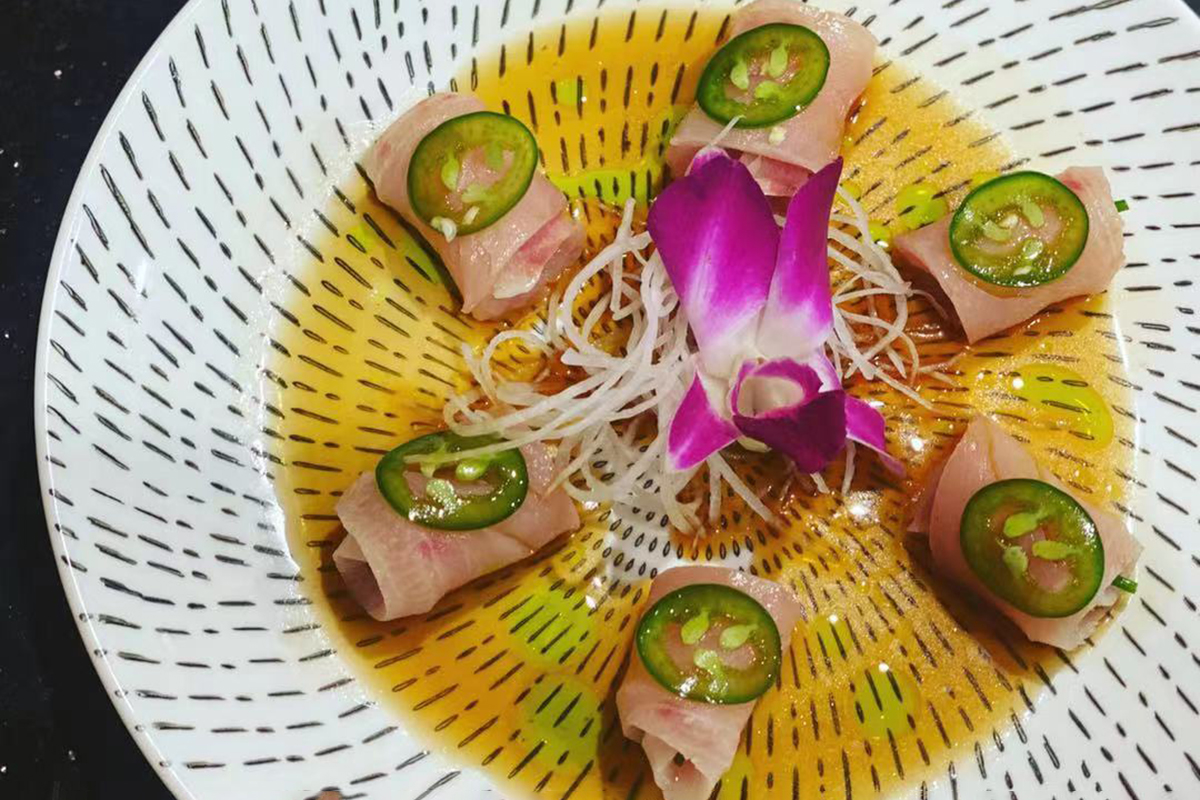 Thin rolled white fish sashimi topped with jalapeno in savory sauce at Komeya Sushi & Ramen, a Japanese Restaurant in Spring