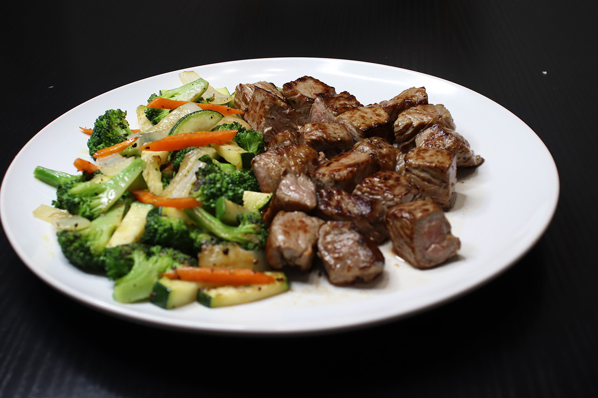Grilled tender steak cubes with colorful stir fry vegetables at Komeya Sushi & Ramen, a Japanese Restaurant in Spring