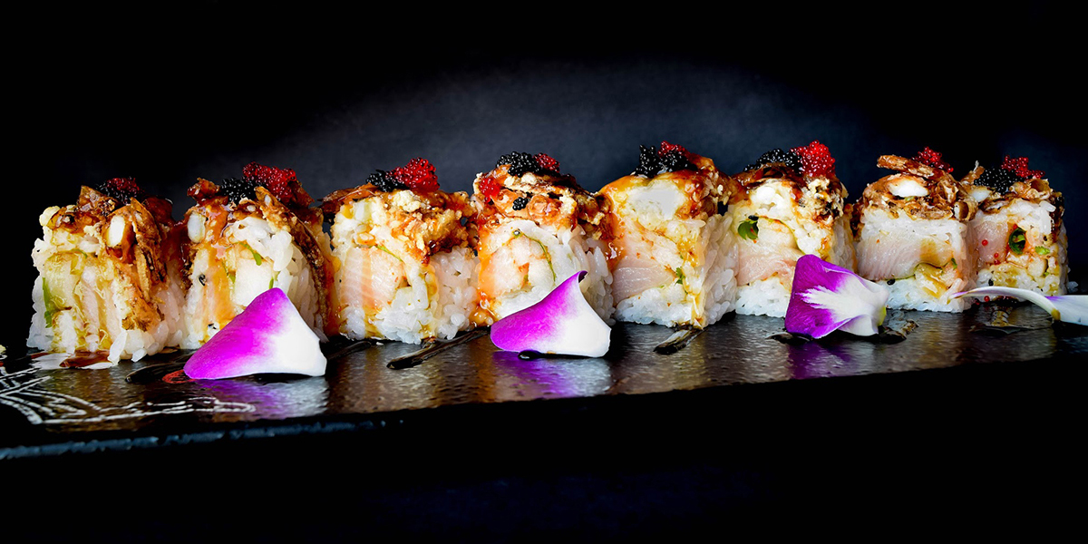 Premium seafood sushi roll with caviar edible flower garnish at Komeya Sushi & Ramen, a Japanese Restaurant in Spring