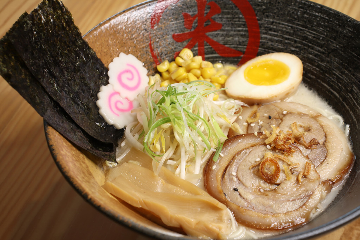 Creamy tonkotsu chashu ramen with soft egg seaweed and fresh toppings at Komeya Sushi & Ramen, a Japanese Restaurant in Spring