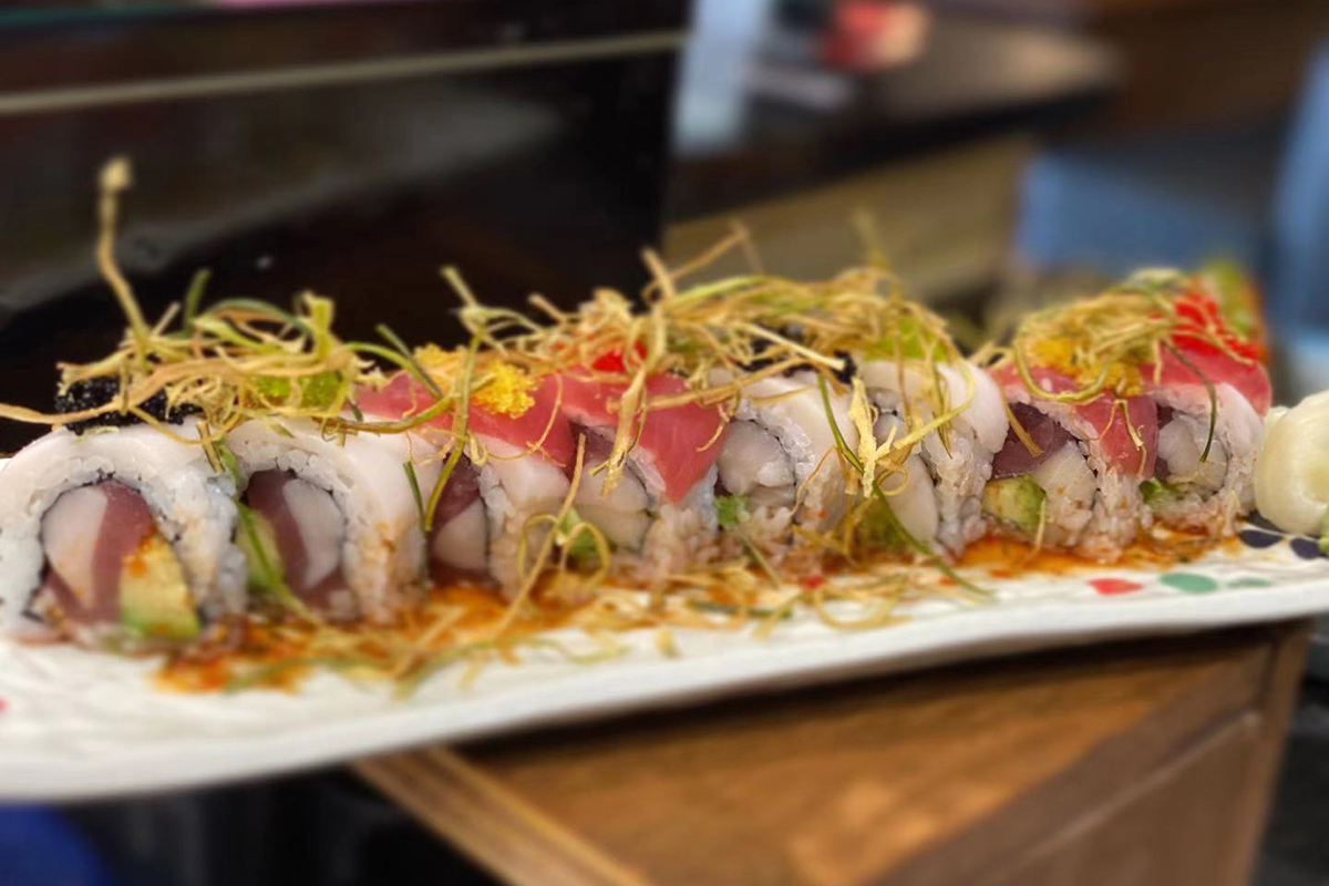 Tuna white fish avocado sushi roll topped with crispy ginger strips at Komeya Sushi & Ramen, a Japanese Restaurant in Spring