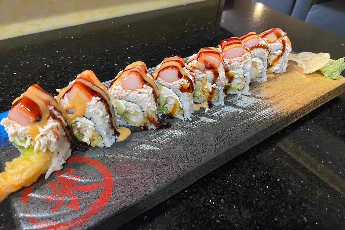 Crab tempura creamy sauce layered sushi roll at Komeya Sushi & Ramen, a Japanese Restaurant in Spring